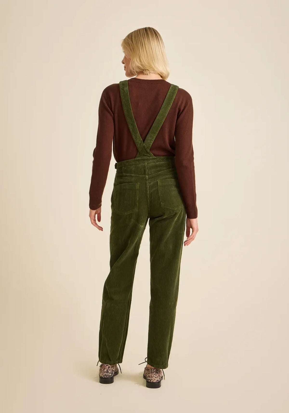 La femme porte la salopette mom coloris vert olive de chez Côtelé Paris 