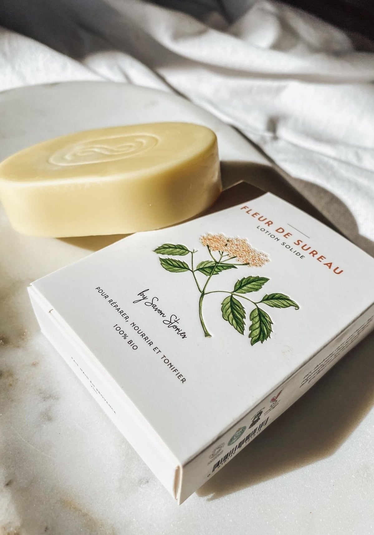 lotion-baume-concentre-solide-fleur-de-sureau-presentation-savon-stories